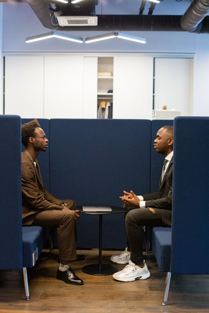 Two professionals in a modern office setting discussing business strategies.